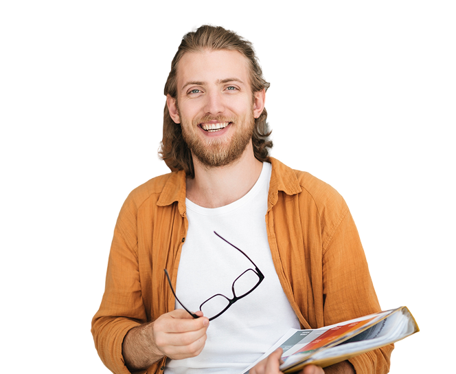 Male graduate with Certificate IV in Business Financial Administration, smiling and holding an eyeglass.